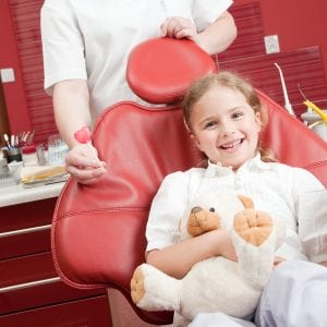 Child sitting in Pediatric Dentist chair